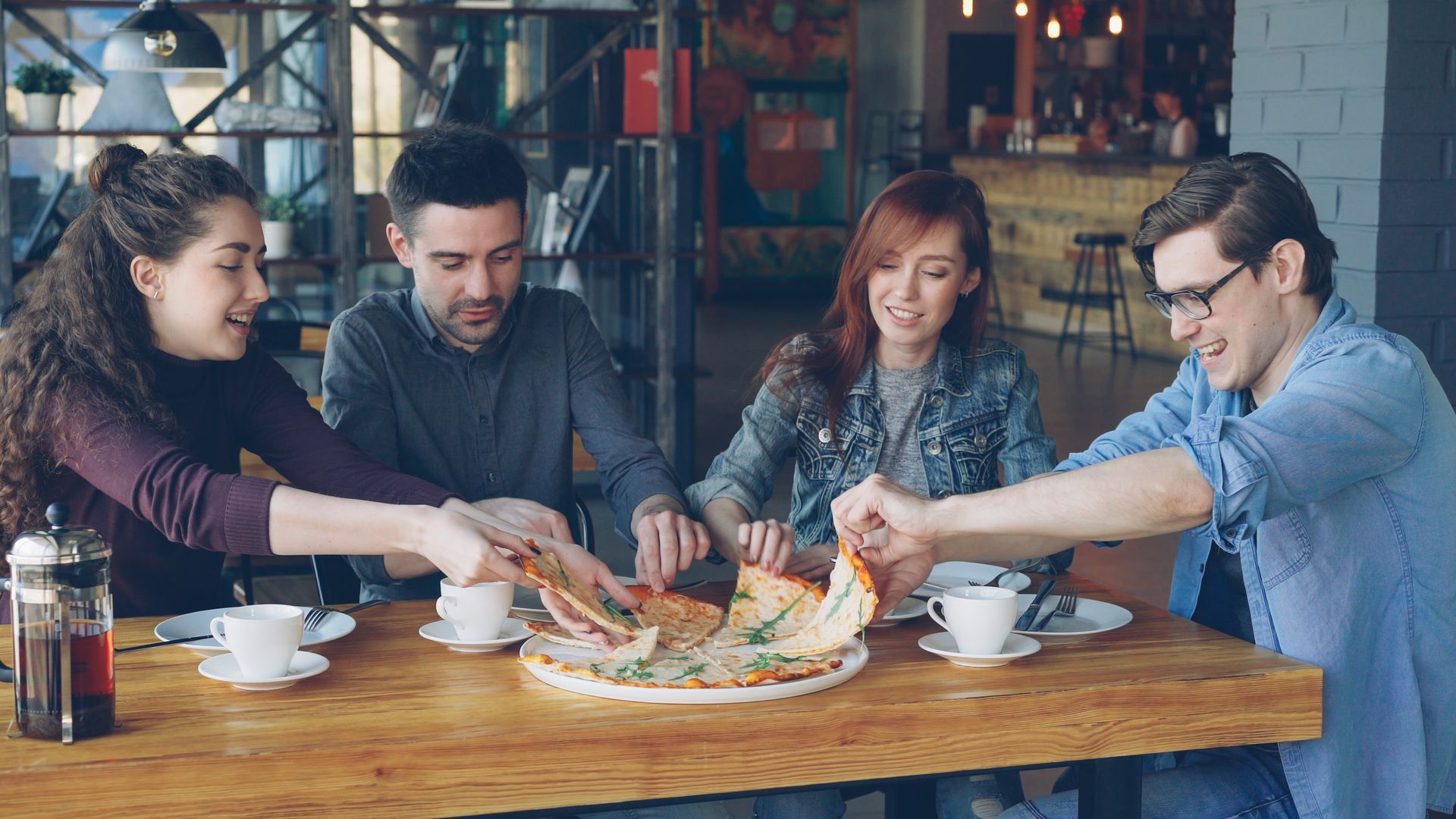 group of friends sharing a pizza