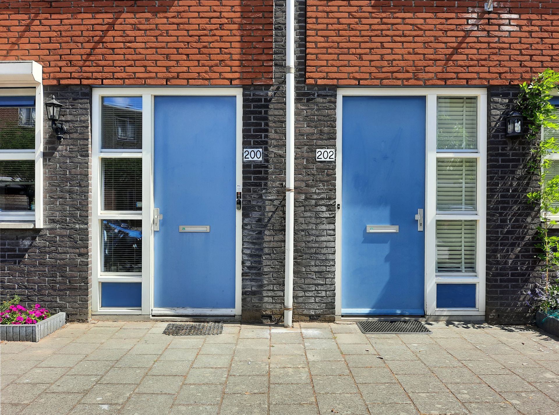 Two plain doors side by side in a bare wall