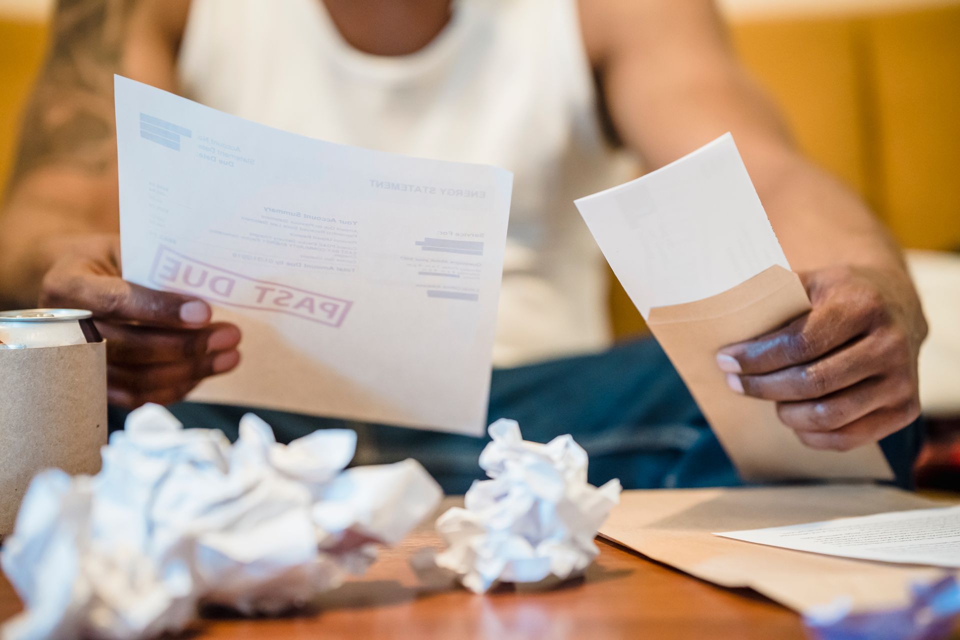 A small pile of curled paper receipts on a plain tabletop